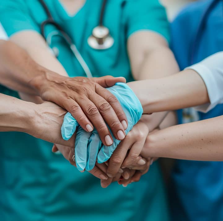 Group of nurses stacking hands together