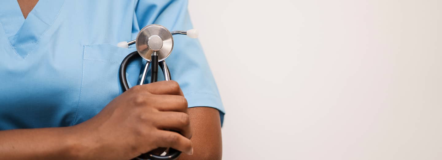 Close shot at a female hand holding a stetoscope