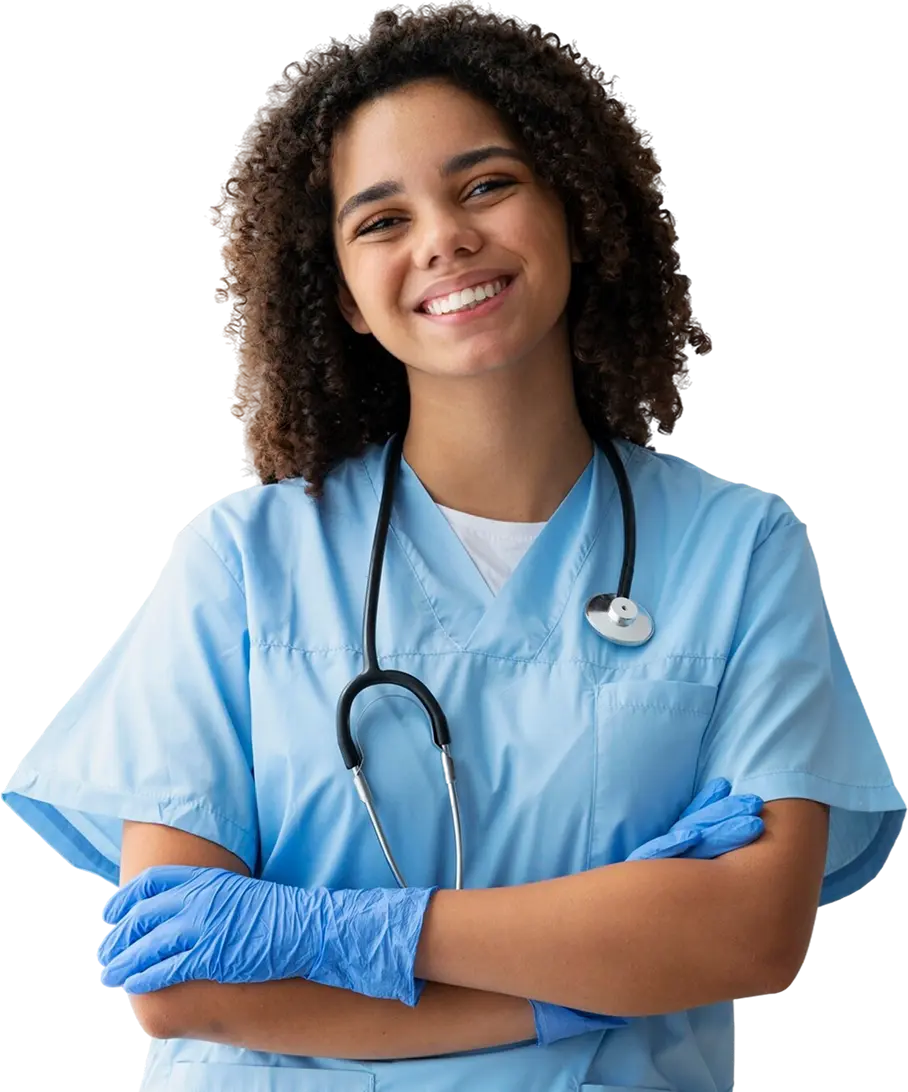Female nurse wearing blue scrubs and blue gloves smiling at the camera